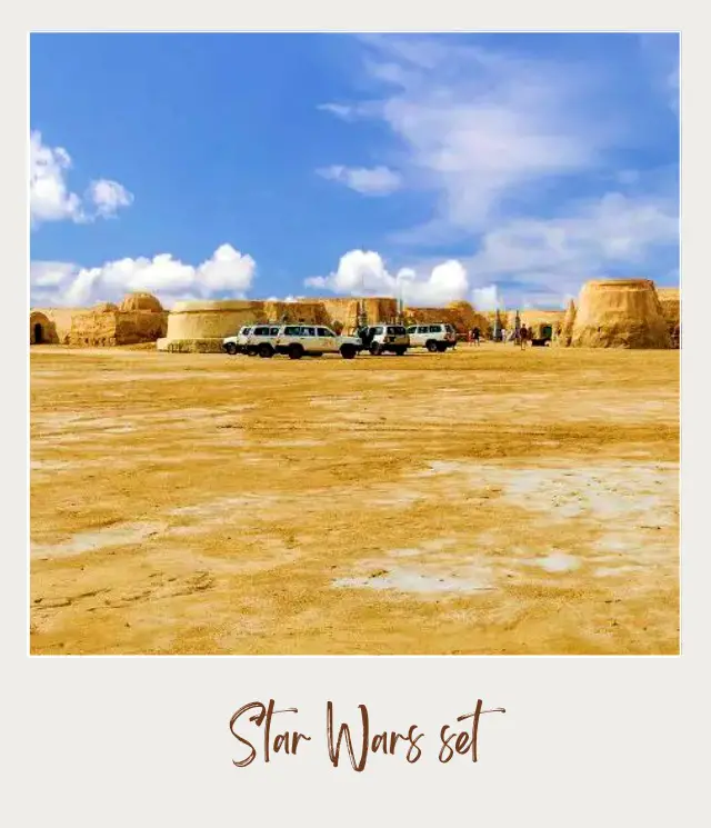 Cars are parked and people are surrounded by rock formations in the middle of the Tatooine Death Valley National Park.