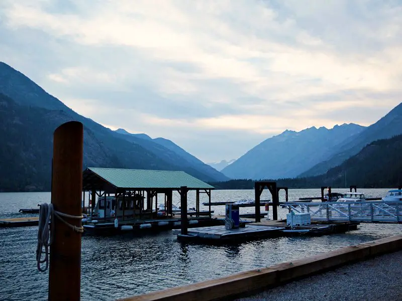 boat dock on lake surrounded by mountains at Stehelin in North Cascades National Park
