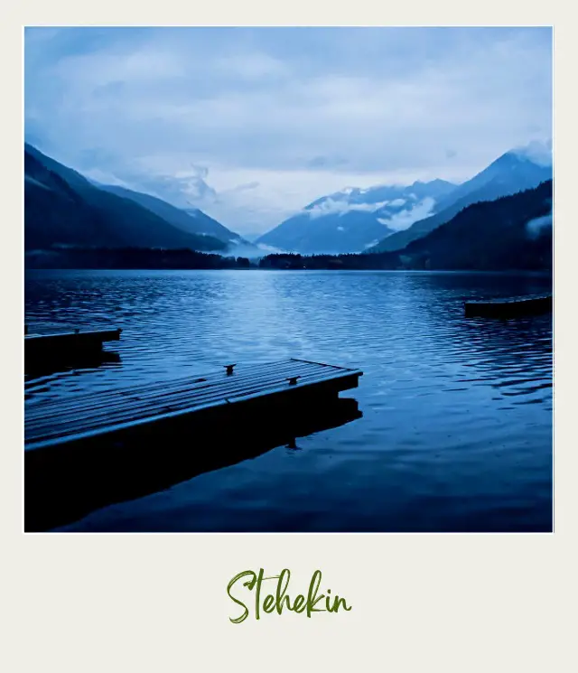 View of a lake with boardwalks surrounded by trees and mountains in North Cascades National Park.