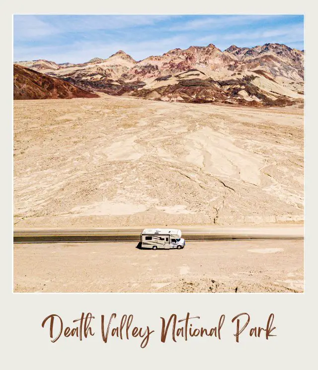 White shuttle bus in the middle of the desert in Death Valley National Park surrounded by mountain ranges.