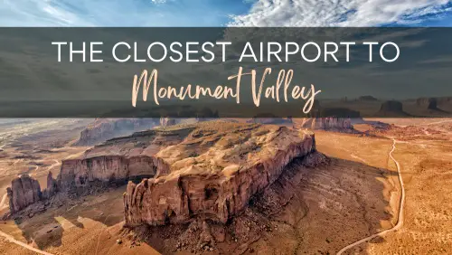 A view of the desert with big rock formation under the blue sky, with the text, Closest Airport to Monument Valley