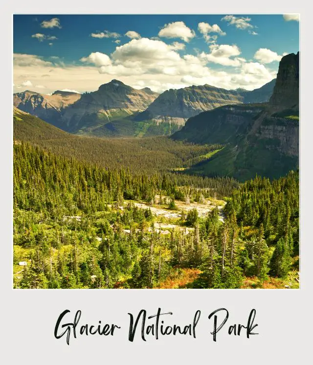 Aerial View of Montains and trees forming U-shaped valley in Glacier National Park.