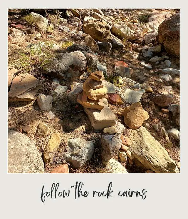 A photo of a pile of rocks sits amidst a rocky landscape at the East Rim Trail in Zion National Park