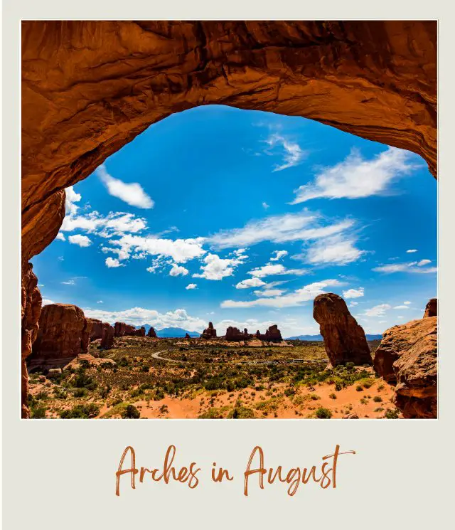 View of huge rock formations and mountains at the distance from the huge rock forming tunnel in Devils Garden in Arches National Park.