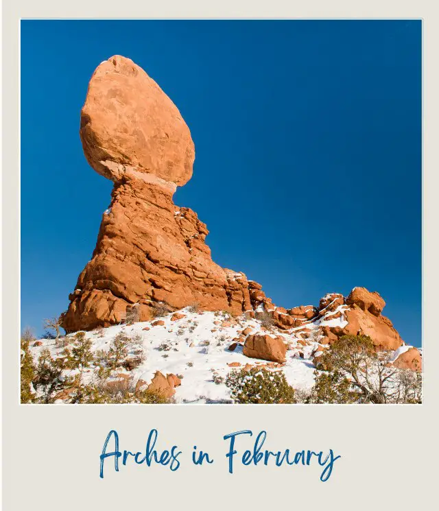 Two huge rock formations covered with snow, surrounded by bushes in Arches National Park