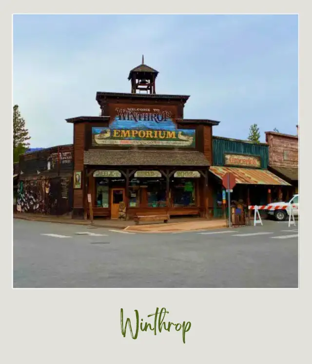 View of wooden store buildings and behind are trees in North Cascades National Park.