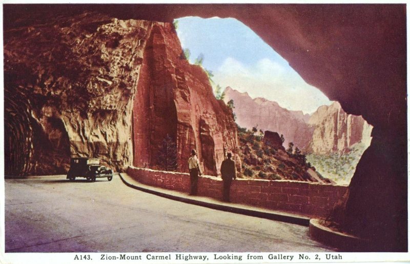old photo of zion national park, old cars, and two men facing huge rock cliffs surrounded by trees